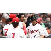 Spokane Indians shortstop Nic Kent is greeted by teammates